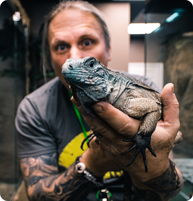 Brian Barczyk holding Bella the blue rhino iguana
