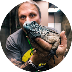Brian Barczyk, founder of The Reptarium, holding iguana